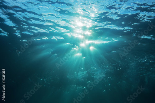 Water surface underwater view of sun rays