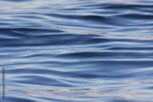 Water waves and ripples. Blue dark and shine.