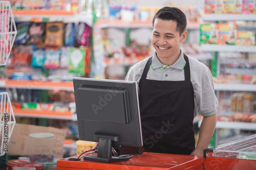 happy asian male shopkeeper photo