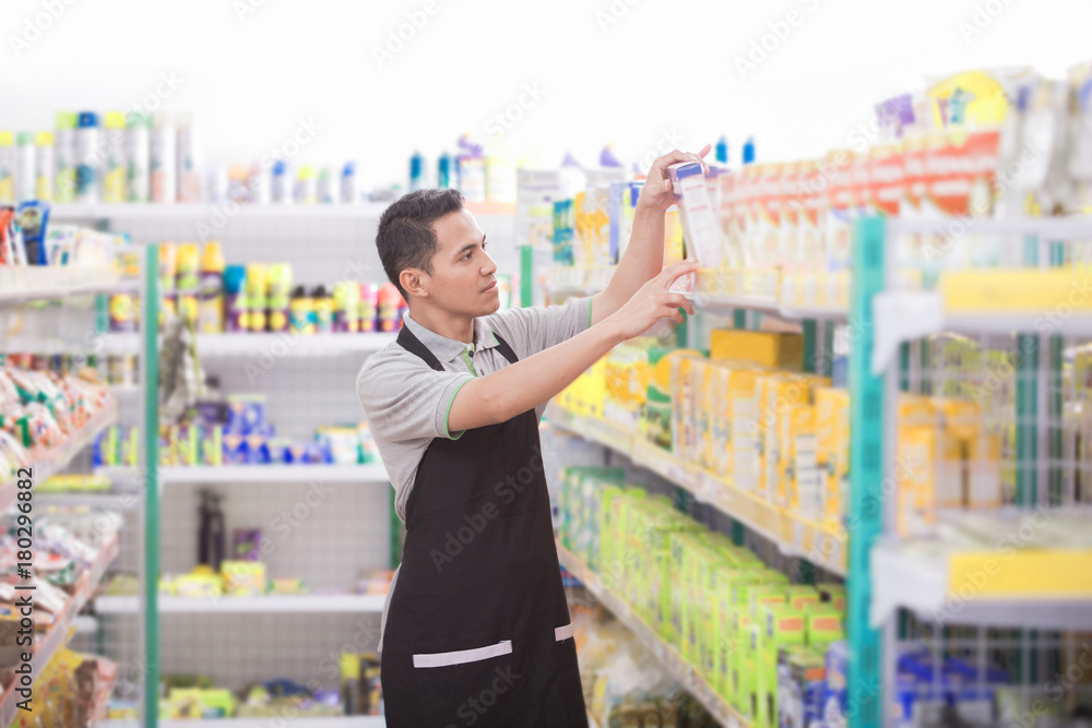male shopkeeper working in a grocery store