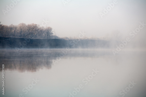 Morning on the river early morning reeds mist fog and water surface on the river © mironovm