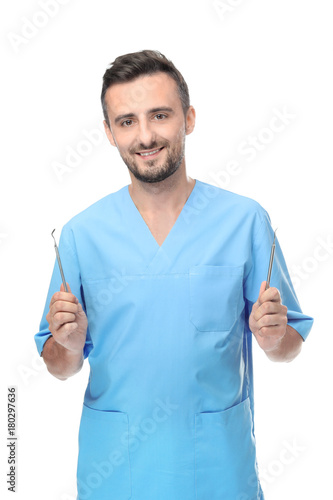 Male dentist with tools on ...