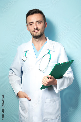 Male doctor with clipboard ...