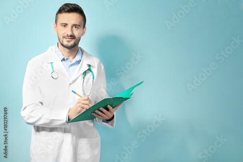 Male doctor with clipboard ...