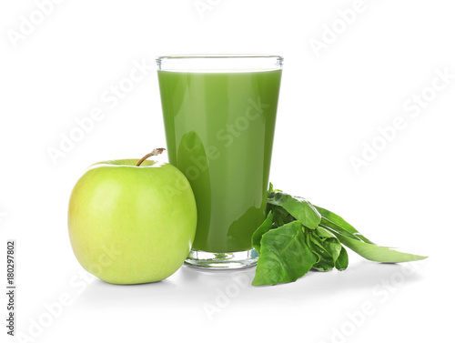 Green juice in glass and ingredients on white background