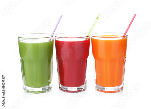 Glasses with various fresh juices on white background