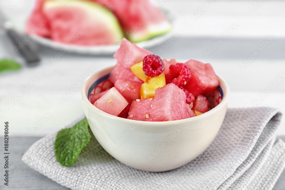 Bowl of fresh salad with watermelon on table Bowl of fresh salad with watermelon on table
