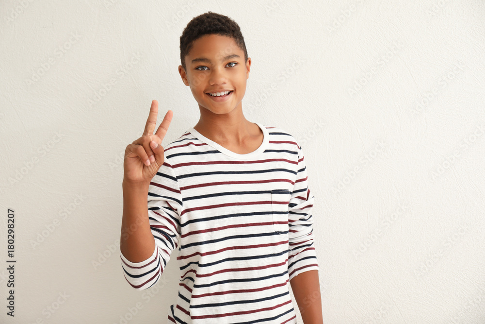 Charming African-American teenager on light background Charming African-American teenager on light background