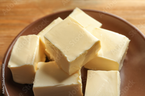 Plate with cubes of butter on table, closeup