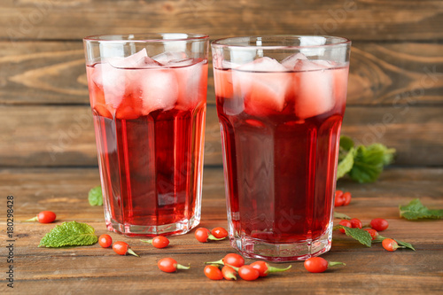 Foto Glasses with goji juice on wooden table