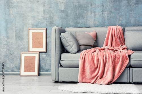 Modern room design with grey sofa