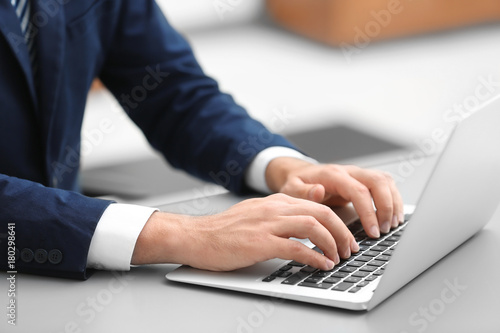 Businessman using his laptop while working in office