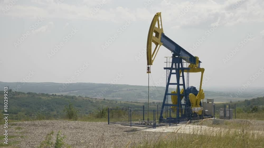 Beautiful landscape hills with pumpjack extracting oil Beautiful landscape hills with pumpjack extracting oil