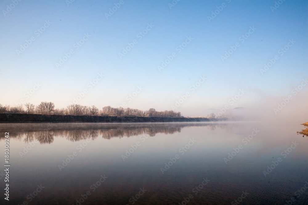 Fototapeta premium Morning on the river early morning reeds mist fog and water surface on the river
