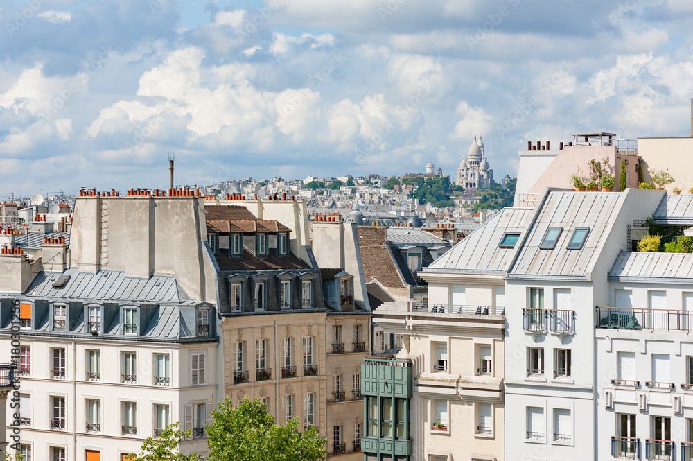Parisian buildings with montmartre and the sacre-coeur in the background, Paris, France