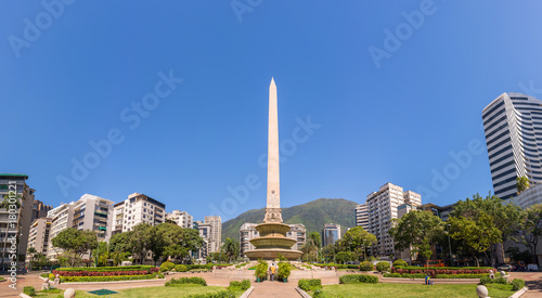 Panoramic view of Altamira's Obelisk on a sunny day with blue skies in Francia Square (A.k.a. Plaza Altamira), in venezuelan capital city Caracas, in 2017.