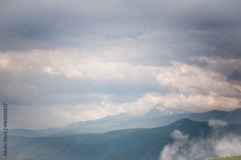 Landscape high mountains in dense fog tops of mountains in clouds North Caucasus Elbrus