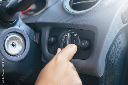 Hand driver turn on light switch in car