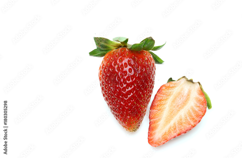 A sliced strawberry and a fresh strawberry on white background ,isolated A sliced strawberry and a fresh strawberry on white background ,isolated