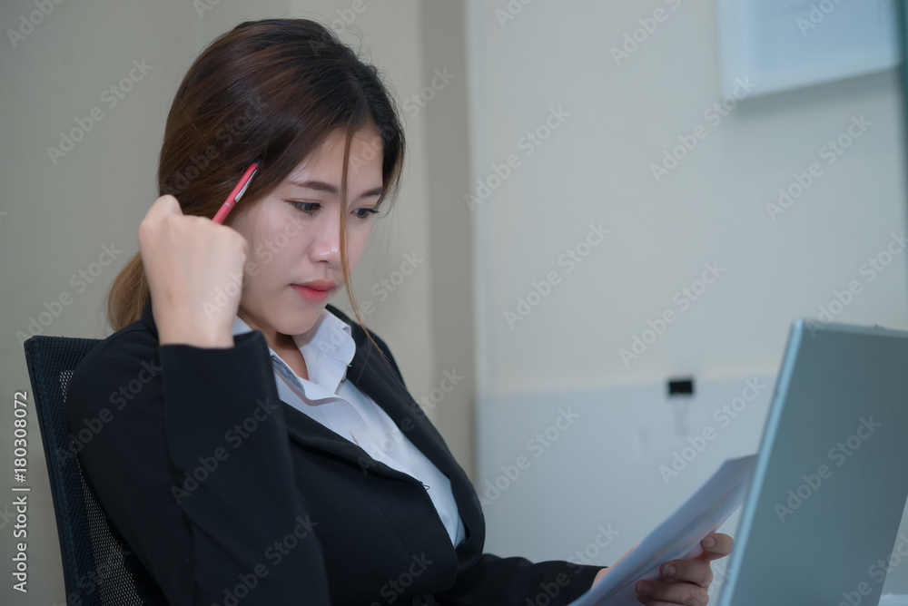Asian beautiful businesswoman think work in the office,vintage style,dark tone,thailand people Asian beautiful businesswoman think work in the office,vintage style,dark tone,thailand people
