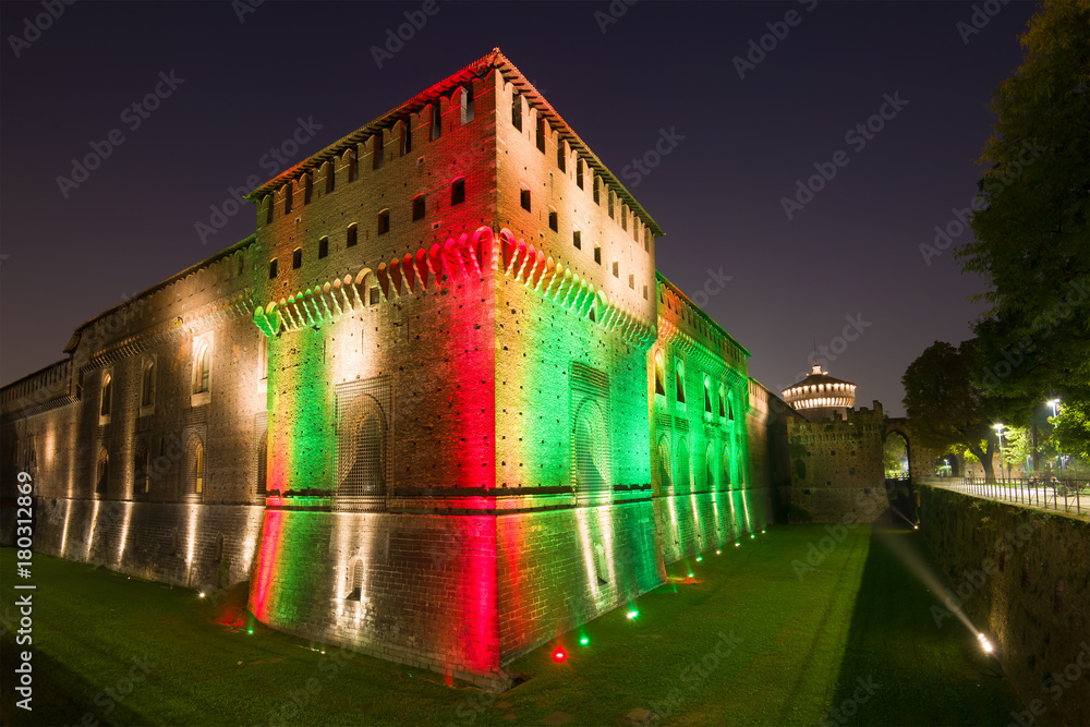 Sforza's castle in a multicolored night illumination. Milan, Italy