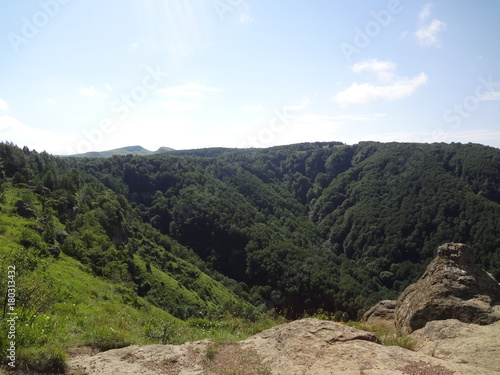 North Caucasus. the mountains. rocks. green Forest. blue sky. clouds. nature. summer. journey. tourism.