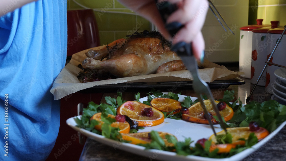 Female Hands Decorate Roasted Whole Chicken on Plate For Family Dinner