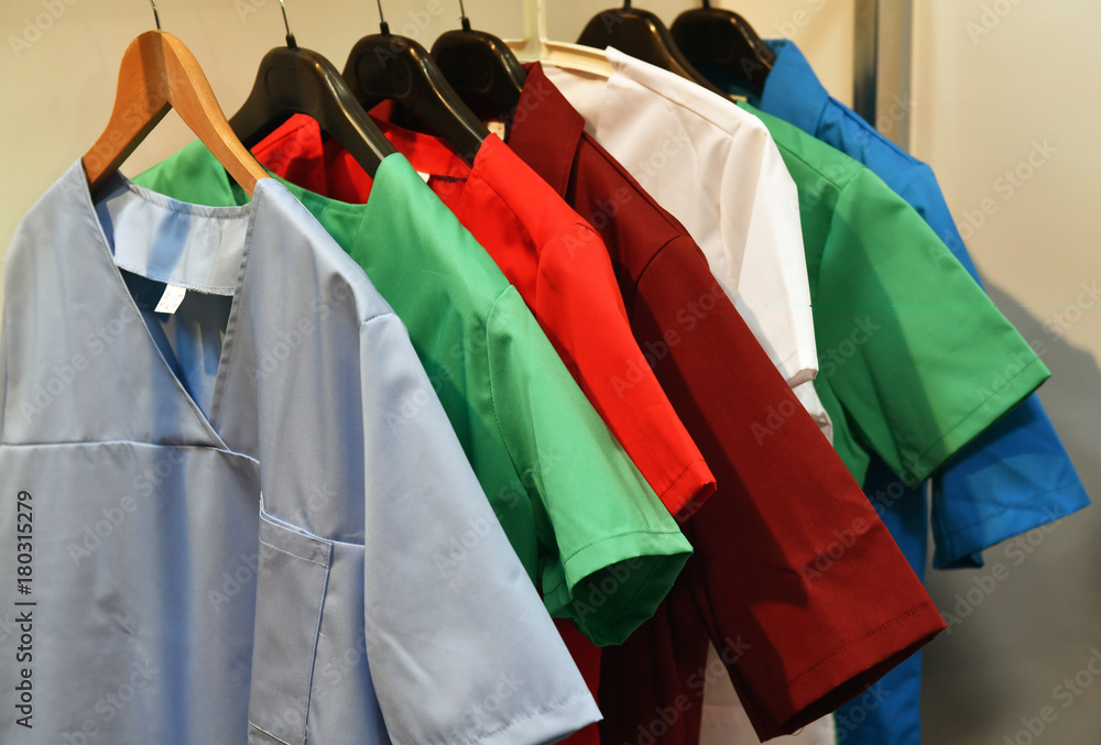 Colored medical coats on hangers