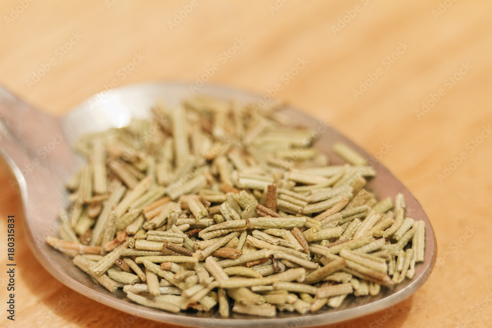 Heap of dried rosemary on a wooden background Heap of dried rosemary on a wooden background