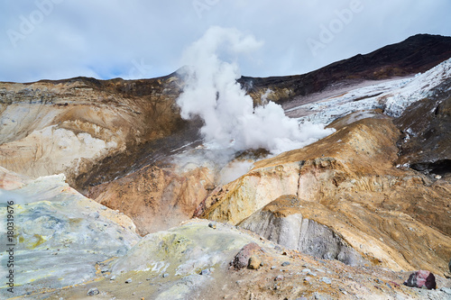 Walking route in the crater of the active volcano Mutnovsky on the Kamchatka Peninsula. Fumarolic fields on thermal areas inside the crater photo