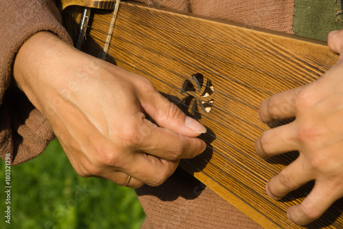Kantele finnish folk musical instrument in man hands photo