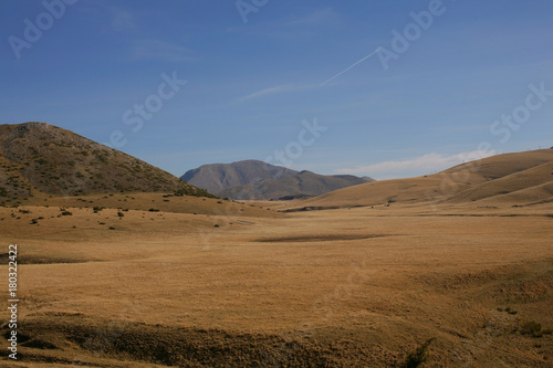 Beautiful treeless meadow in a mountain on a sunny day; nature background. 