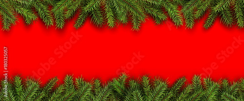 Christmas background green fir tree branches on red