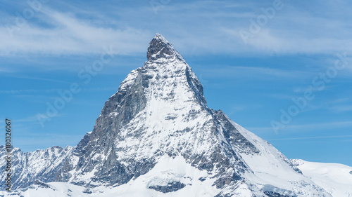 Snowy Matterhorn peak with blue sky and some clouds in background, Switzerland © CanYalicn
