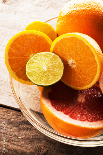 Citrus fruits - oranges  limes  grapefruits. On wooden background