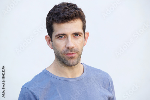 Close up serious caucasian man standing on white background
