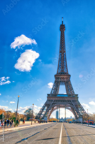 PARIS, FRANCE - DECEMBER 2012: Tourists visit Eiffel Tower. The city attracts 40 million people every year