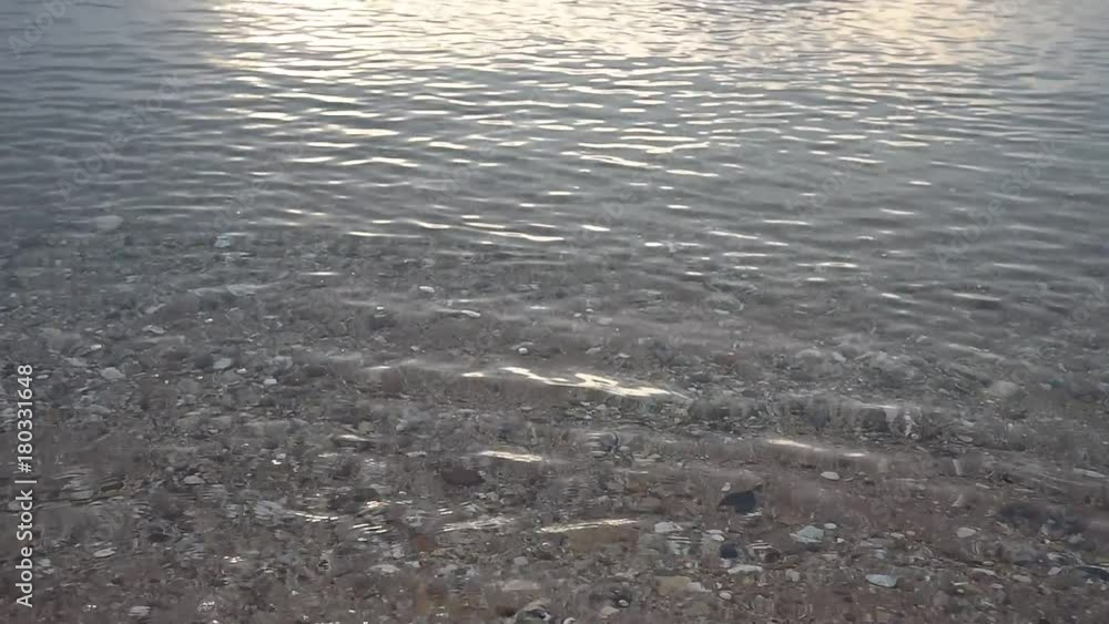 Sea water surface and sand background below Sea water surface and sand background below