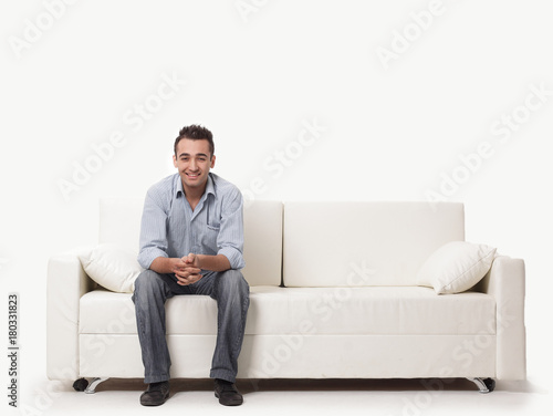 young man sitting on a modern sofa