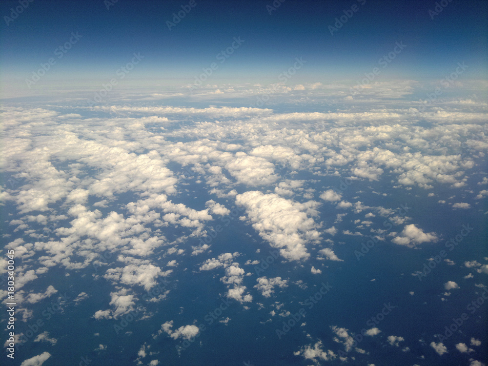 Above the sky. Flying over clouds in plane.
