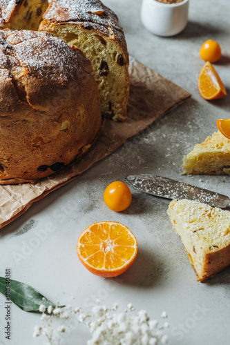 Traditional Christmas Panettone. Close-up of slice of Italian homemade cake with oranges and raisins.