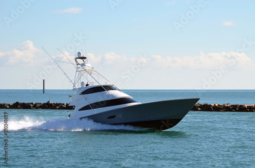 Upscale sport fishing boat speeding back to its home port after spending the day at sea.