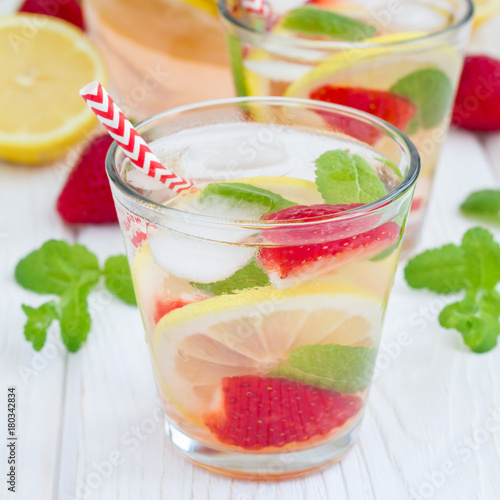 Strawberry mint homemade lemonade on white wooden table, square