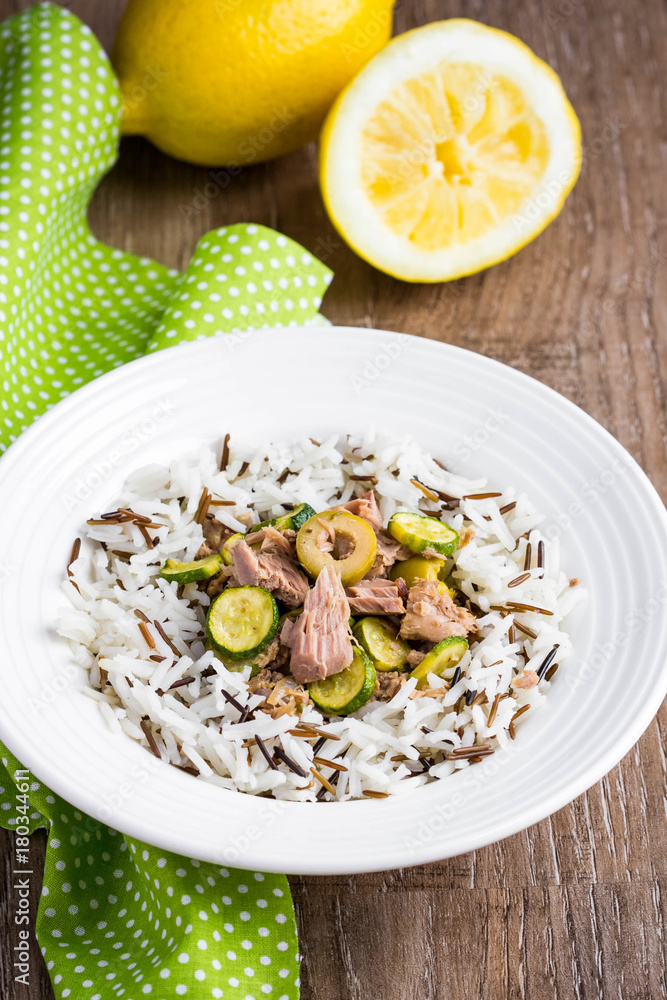Mix of wild and white rice with canned tuna, zucchini, green olives and lemon, fresh, tasty diet dish, healthy food