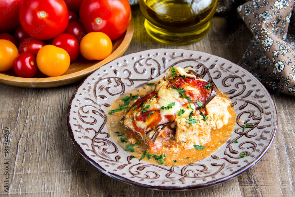 Parmigiano with tomatoes, eggplant, cheese, meat, chicken, traditional dish, tasty homemade food