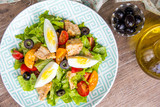 Green salad with chicken, lettuce, egg, olives, tomatoes, healthy lunch, tatsy
