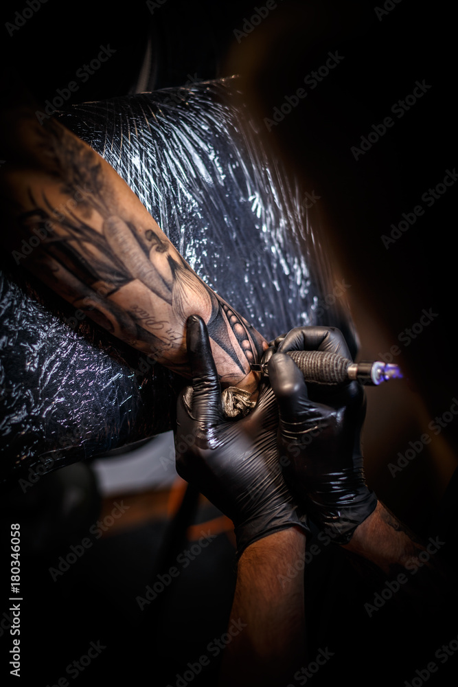 Artist making tattoo Artist making tattoo