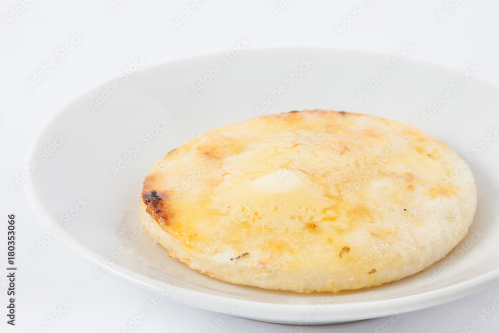 Traditional Colombian arepa topped with melted butter
