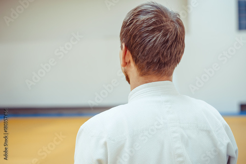 man in kimono standing with her back