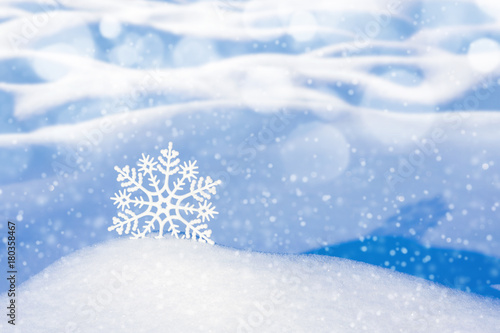 Christmas background with decorative snowflake among snowdrifts © Leonid Ikan